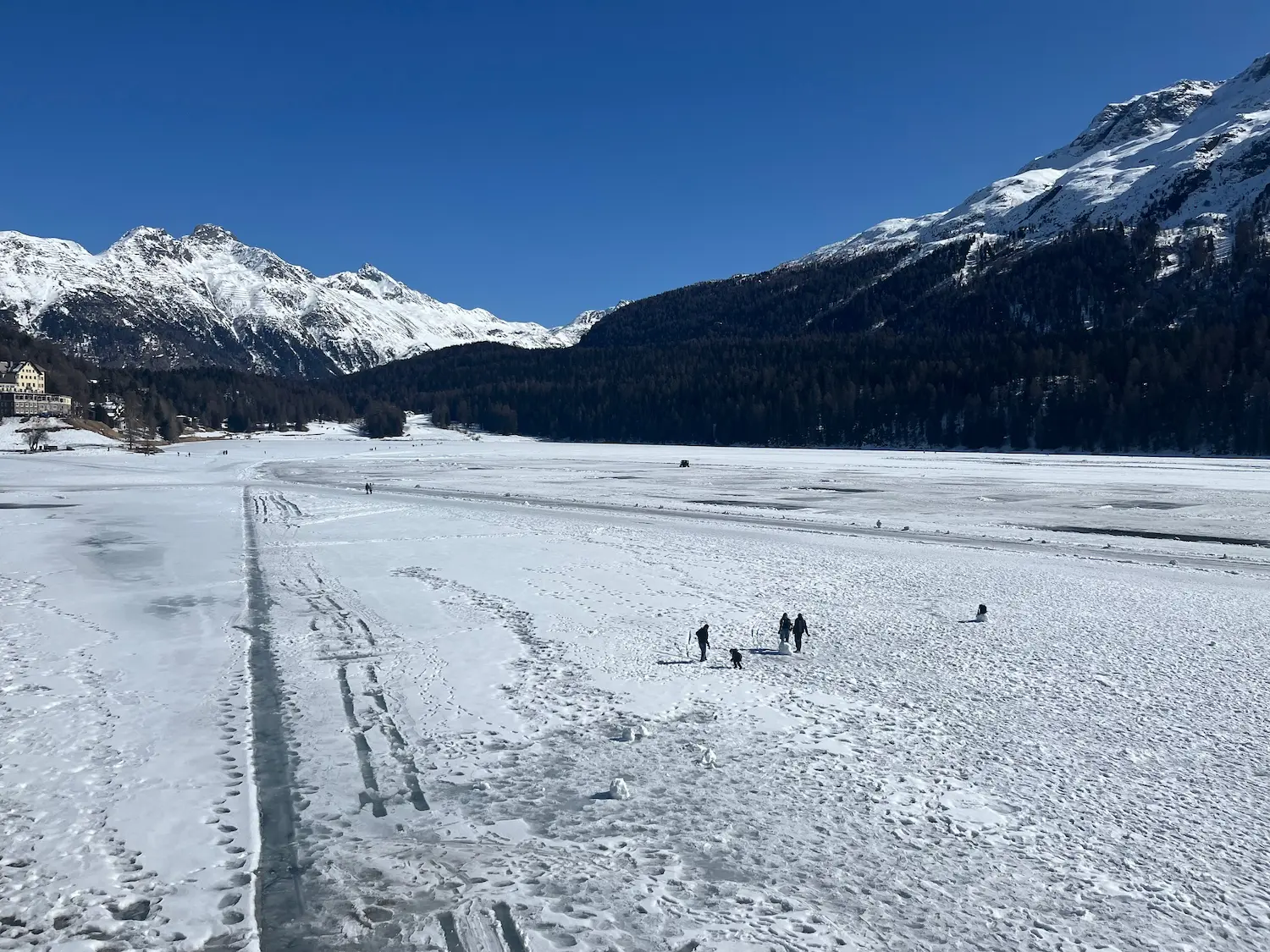 The vast frozen expanse of Lake St Moritz in winter with the Engadin Alps rising steeply on both sides