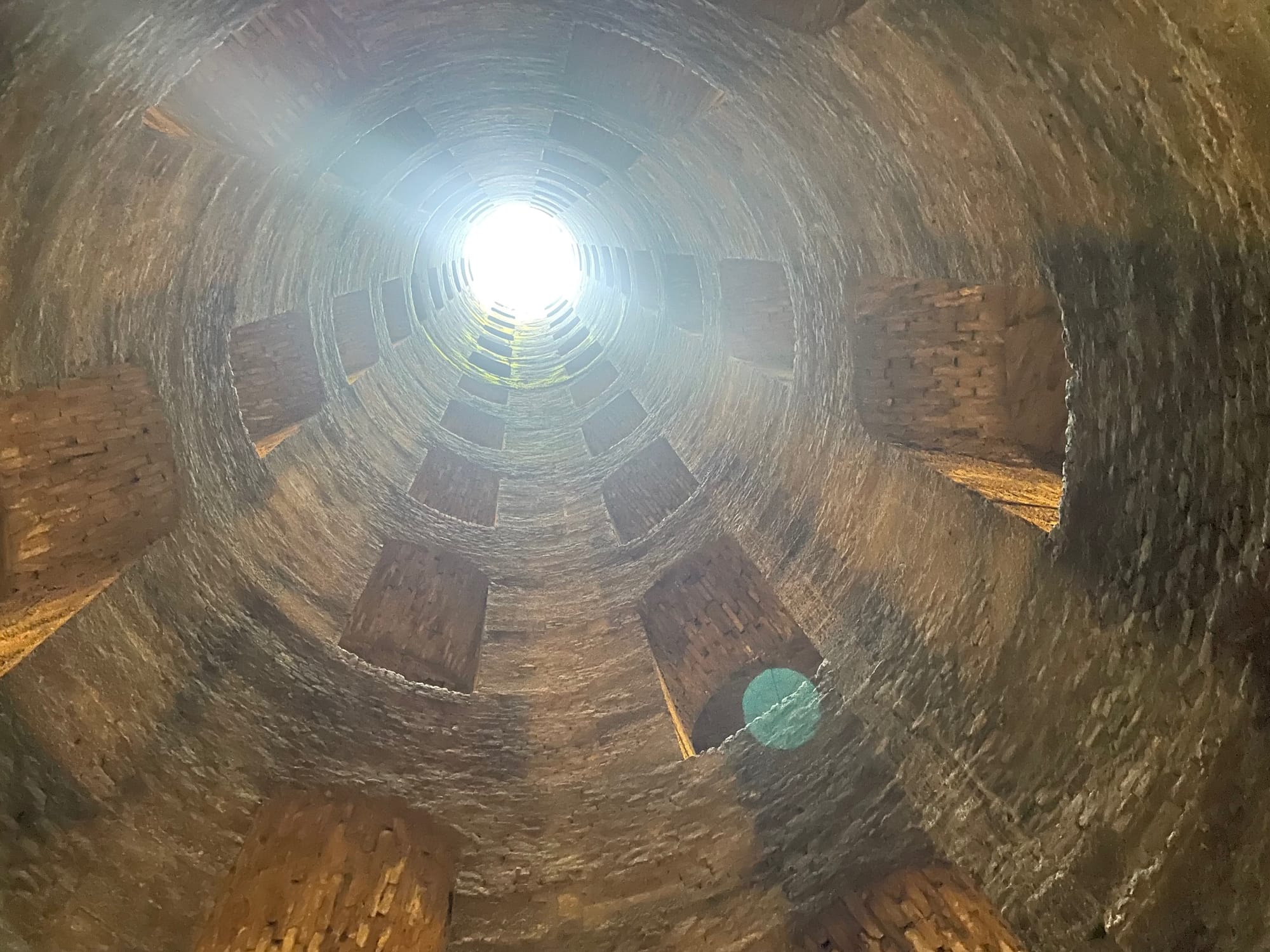 Looking up from the bottom of Pozzo di San Patrizio, Orvieto — the twin spiral staircases visible above