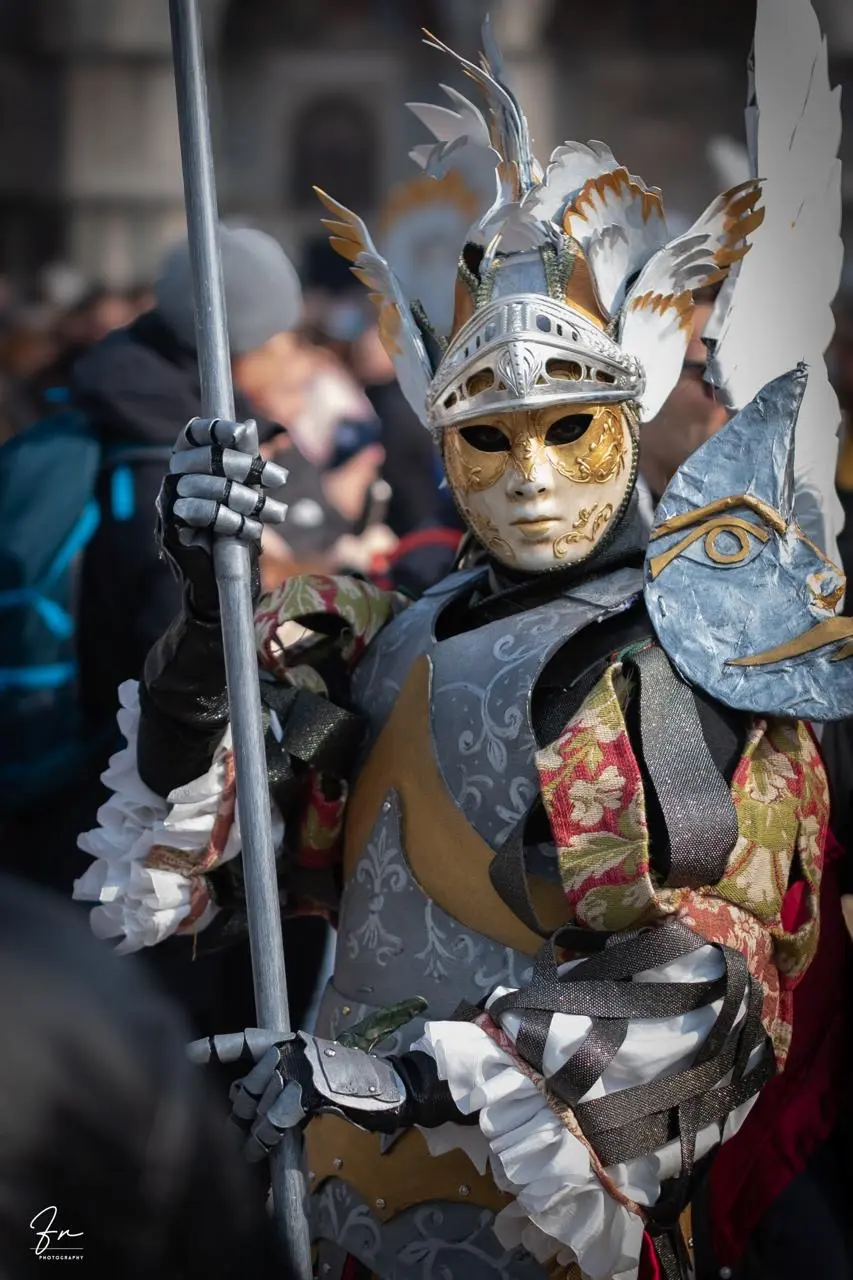 Venice Carnival costume styled as a silver winged warrior with an ornate feathered helmet