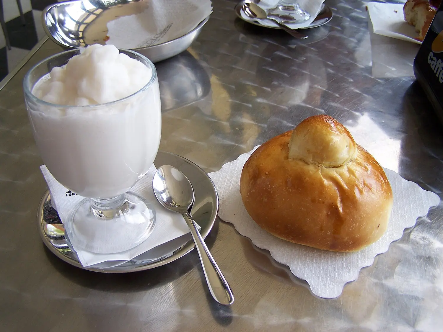 Lemon ice (granita) with brioche - a typical Sicilian breakfast