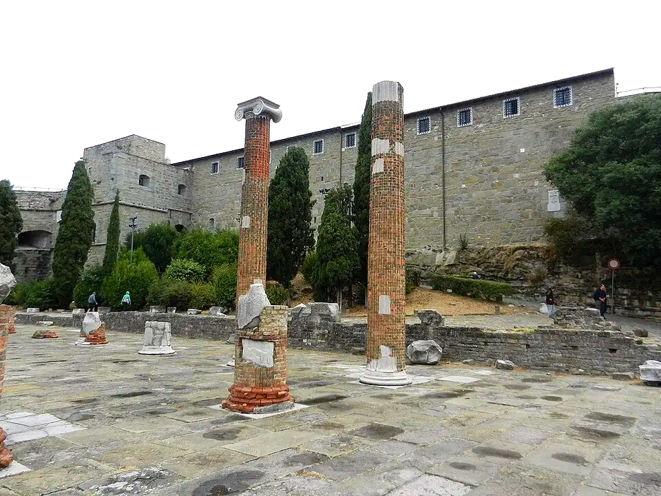 Ruins of the Roman Basilica and behind, the medieval Castello di S. Giusto