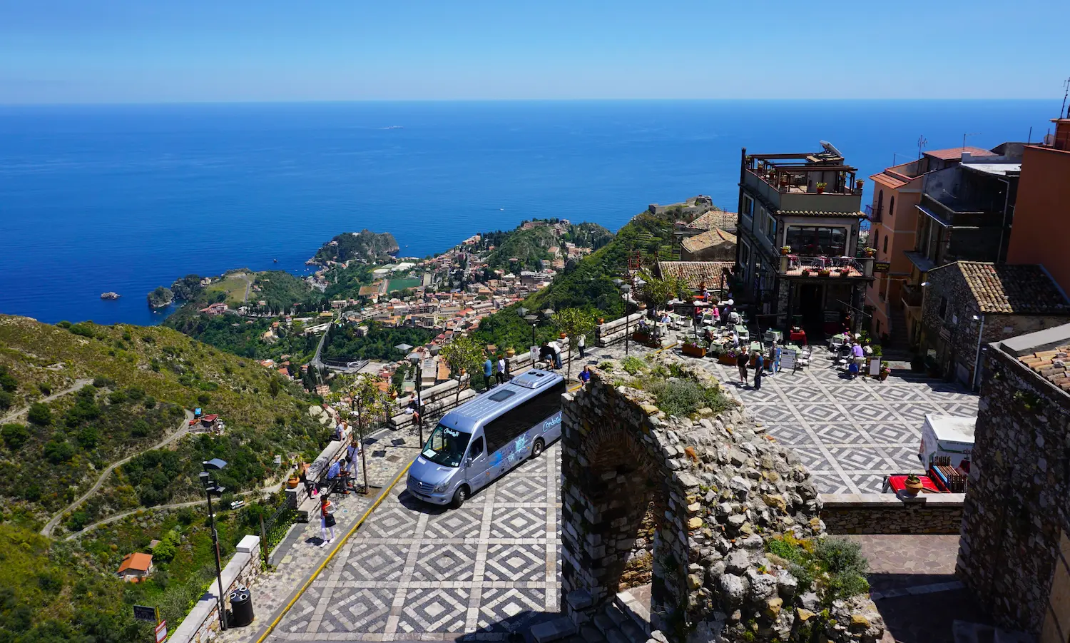 The local bus in the square in front of Castelmola, and the views down to the bay